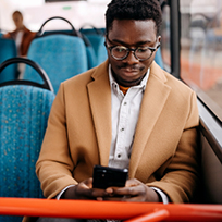 man reading phone on bus