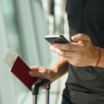 mobile device and passport on luggage